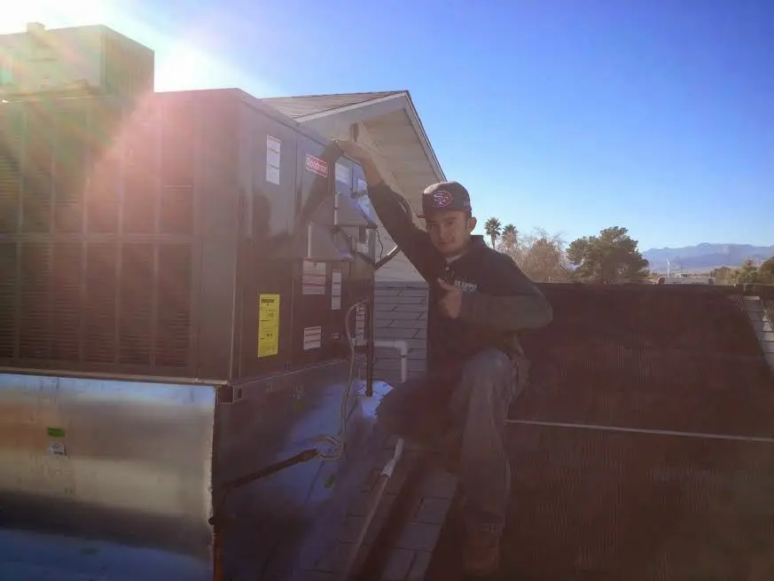 HVAC technician performing Air Duct Cleaning on a rooftop unit in Cresaptown